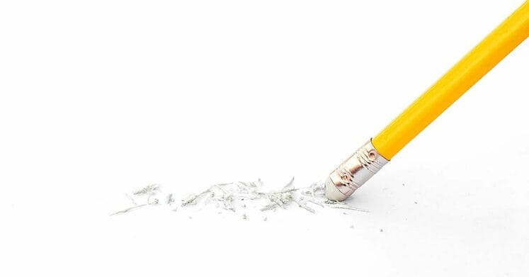 Close up of a pencil eraser removing on a white paper. Concept of error and correction.